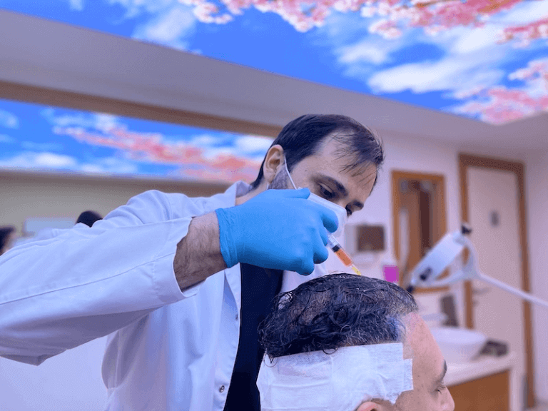 Doctor Utkan Working On An After Hair Transplant Injection