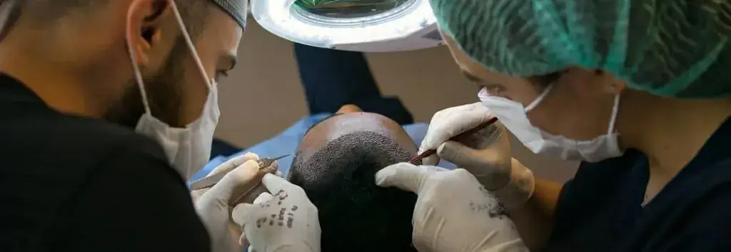 Dermatologists working on a hair transplant